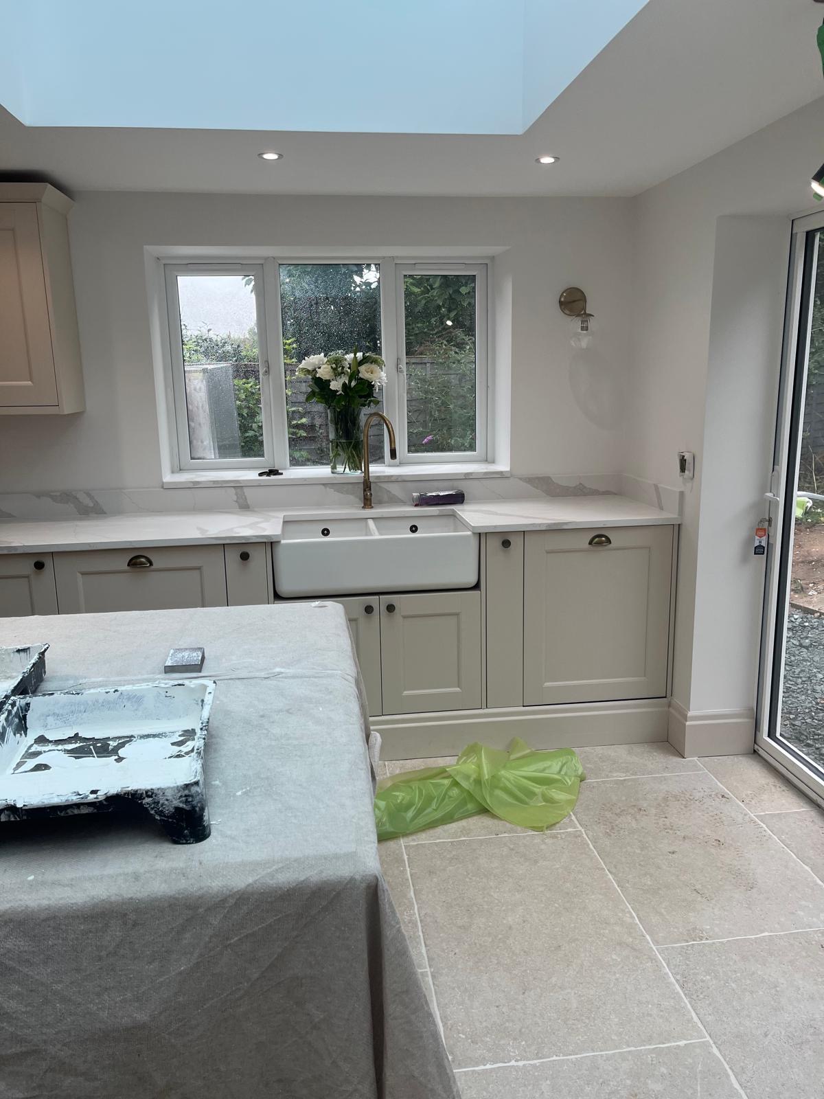 Belfast sink and marble-style worktops in a renovated kitchen
