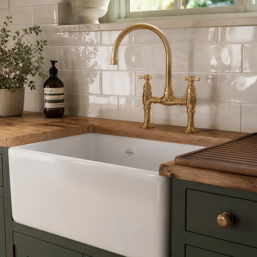Close-up of brass swan-neck tap and Belfast sink